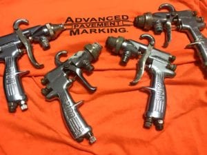 Pavement marking applicator guns
